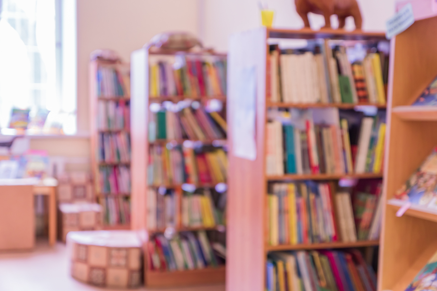 public library for children defocused intereor. shelving with books